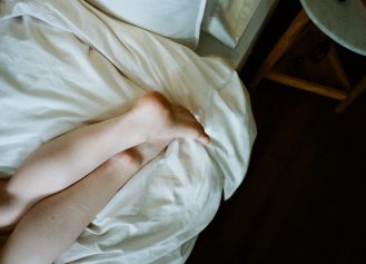 Feet of a woman lying on a bed