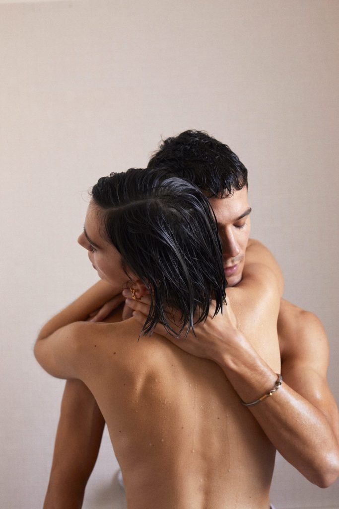 Naked and wet couple holding each other